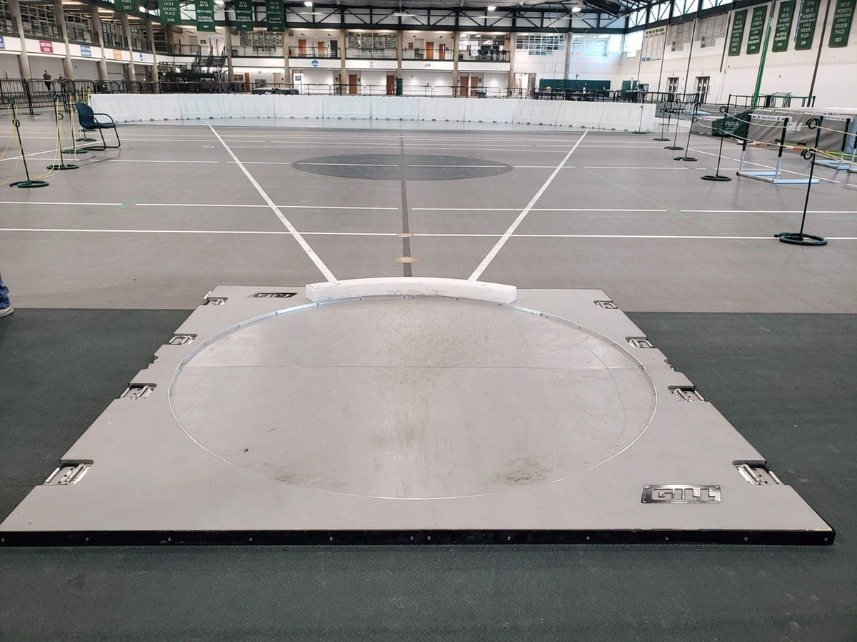 Gill portable indoor throwing platform set up in a field house