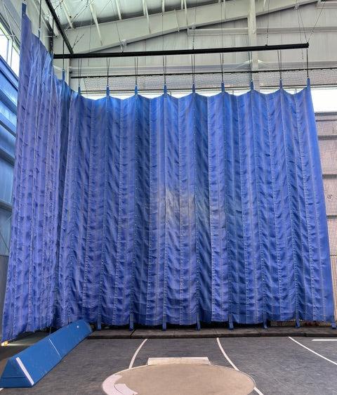 Shot put thrown into an EvelTarp throwing curtain